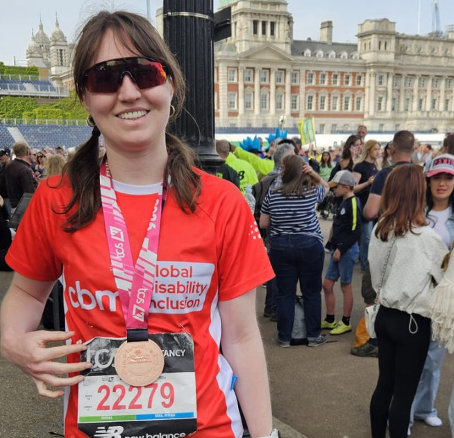 Amelia wearing her london marathon medal