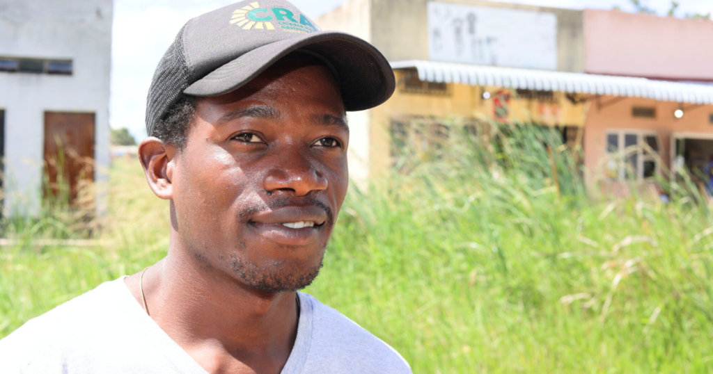 A man from Zimbabwe wearing a baseball cap. He has cataracts.