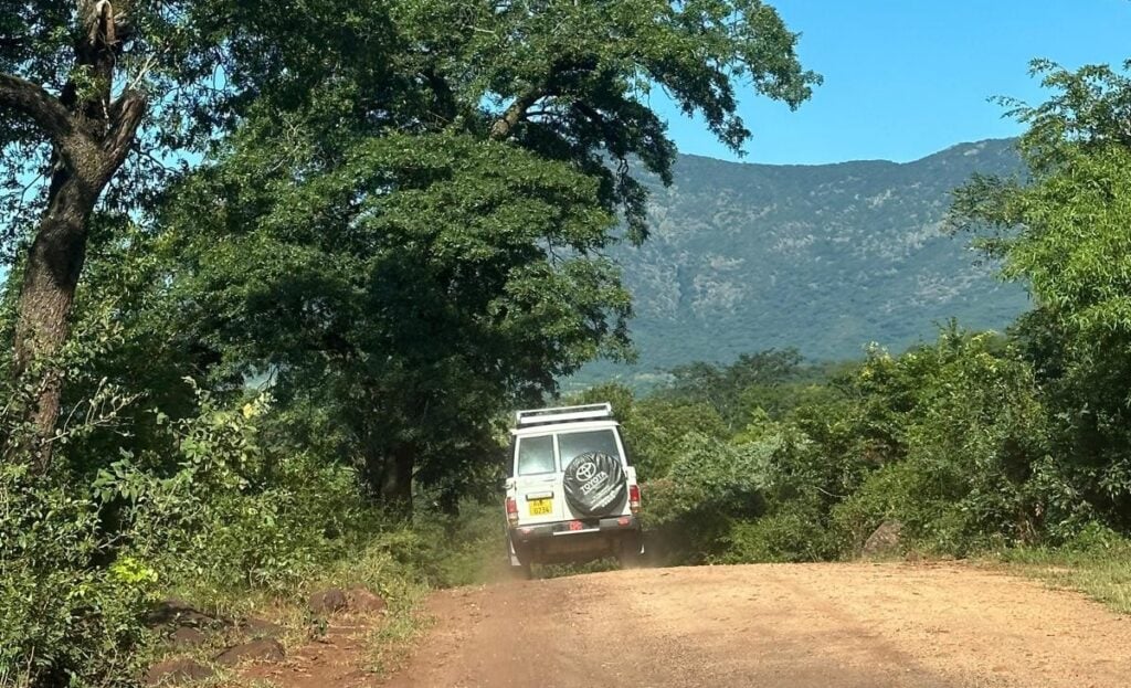 A vehical driving through Zimbabwe bump roads.