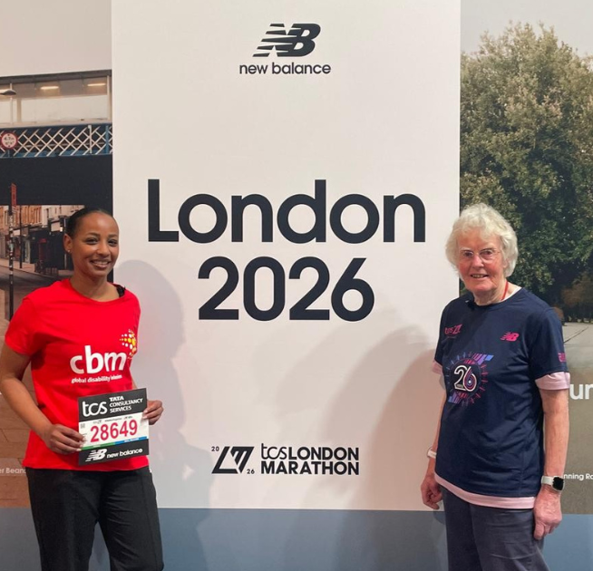 Arwa standing in front of the London Marathon 2026 sign